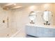 This bathroom features a dual sink vanity with marble tiling in the shower and shower fixtures at 678 Wagner St, Troutman, NC 28166