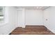Bedroom featuring a closet, an entry door, a window and hardwood floors at 678 Wagner St, Troutman, NC 28166