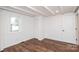 Bright bedroom boasts hardwood floors, crisp white walls, a large window, and ample closet space at 678 Wagner St, Troutman, NC 28166