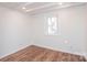 Bright bedroom with wood-look floors, white walls, ceiling beams and window at 678 Wagner St, Troutman, NC 28166