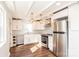 Spacious kitchen with stainless steel appliances, bright white cabinets, granite counters, and modern lighting at 678 Wagner St, Troutman, NC 28166