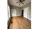 Bedroom with hardwood floors, window, ceiling fan, and built-in shelves at 705 3Rd Nw Ave, Hickory, NC 28601