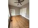 Bright bedroom features hardwood floors, window, ceiling fan, and built-in shelves at 705 3Rd Nw Ave, Hickory, NC 28601