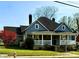Charming two-story home featuring a welcoming front porch with white railing and well-maintained landscaping at 705 3Rd Nw Ave, Hickory, NC 28601