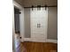 Hallway featuring closet with sliding barn doors and wood floors at 705 3Rd Nw Ave, Hickory, NC 28601