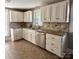 Bright kitchen with white cabinets, stainless steel dishwasher, and stylish backsplash at 705 3Rd Nw Ave, Hickory, NC 28601