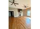 Living room with hardwood floors, shiplap, a fireplace, and two ceiling fans at 705 3Rd Nw Ave, Hickory, NC 28601