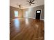 Open living room has hardwood floors, a black door, and two windows at 705 3Rd Nw Ave, Hickory, NC 28601
