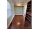 Walk-in closet with built-in shelving and hardwood flooring at 705 3Rd Nw Ave, Hickory, NC 28601