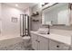 Well-lit bathroom features a sleek vanity, patterned floor tiles, and shower-tub combo at 718 W Trade St # 808, Charlotte, NC 28202