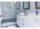 Bright bathroom featuring a walk-in shower, tile accents, and double sinks at 718 W Trade St # 808, Charlotte, NC 28202