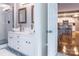 Bathroom features double sinks, white cabinets, and walk-in shower at 718 W Trade St # 808, Charlotte, NC 28202