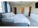 Bright bedroom features neutral decor, multiple windows, and ensuite bathroom at 718 W Trade St # 808, Charlotte, NC 28202