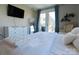 Bedroom features balcony access, neutral decor, and a large window at 718 W Trade St # 808, Charlotte, NC 28202