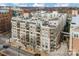 An attractive condo building with balconies and a rooftop deck in an urban setting at 718 W Trade St # 808, Charlotte, NC 28202