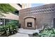 An outdoor brick fireplace with a cozy seating area and landscaped surroundings at 718 W Trade St # 808, Charlotte, NC 28202