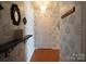 Inviting hallway featuring stylish wallpaper, decor, and a modern light fixture at 718 W Trade St # 808, Charlotte, NC 28202