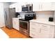 Modern kitchen equipped with stainless steel appliances, white countertops, and ample cabinet space at 718 W Trade St # 808, Charlotte, NC 28202
