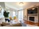 Bright living room with fireplace, gleaming floors, and flooded with natural light at 718 W Trade St # 808, Charlotte, NC 28202