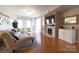 Light-filled living room features a fireplace, wood floors, and neutral decor at 718 W Trade St # 808, Charlotte, NC 28202