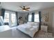 Bright main bedroom with white linens, large windows, and a private balcony access at 718 W Trade St # 808, Charlotte, NC 28202