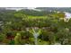Beautiful aerial view of a wooded residential area with lake access and manicured lawns at 7268 Kiskadee Dr, Denver, NC 28037
