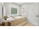 Bathroom with a tub, tiled deck, tile flooring, window and a closed door at 7268 Kiskadee Dr, Denver, NC 28037