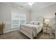 Cozy bedroom with a stylish wooden bed frame, soft carpet, and a bright window at 7268 Kiskadee Dr, Denver, NC 28037