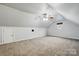 Expansive bonus room with carpet floors, neutral walls and a view from the small window at 7268 Kiskadee Dr, Denver, NC 28037