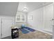 A bonus room with exercise mats, natural light and a door leading to other parts of the house at 7268 Kiskadee Dr, Denver, NC 28037