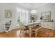 Bright dining room with hardwood floors, stylish furnishings, and large windows at 7268 Kiskadee Dr, Denver, NC 28037
