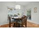 Bright dining nook with a chandelier fixture and four chairs at the table at 7268 Kiskadee Dr, Denver, NC 28037