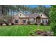 Charming brick home with a well-manicured lawn and inviting front entrance at 7268 Kiskadee Dr, Denver, NC 28037