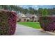 Charming brick home with manicured lawn, blooming bushes, and concrete driveway at 7268 Kiskadee Dr, Denver, NC 28037