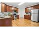 Functional kitchen with wood cabinets, stainless steel appliances, and granite countertops at 7268 Kiskadee Dr, Denver, NC 28037