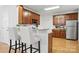 Kitchen featuring wooden cabinets, stainless steel appliances, and a breakfast bar at 7268 Kiskadee Dr, Denver, NC 28037