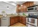 Close-up of the kitchen featuring stainless steel appliances and granite countertops at 7268 Kiskadee Dr, Denver, NC 28037