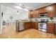 View of the updated kitchen with stainless steel appliances and granite countertops at 7268 Kiskadee Dr, Denver, NC 28037