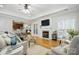 Inviting living room featuring a fireplace, hardwood floors, and a cozy seating area at 7268 Kiskadee Dr, Denver, NC 28037