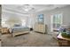 Bright primary bedroom with a cozy chair, dresser, large bed and carpet flooring at 7268 Kiskadee Dr, Denver, NC 28037