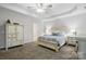 Primary bedroom featuring matching nightstands, a queen bed, carpet, and a ceiling fan at 7268 Kiskadee Dr, Denver, NC 28037