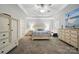 Spacious primary bedroom features a tray ceiling, dresser and a large bed at 7268 Kiskadee Dr, Denver, NC 28037