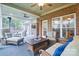 Relaxing screened patio with comfortable seating, ceiling fans, brick accents and outdoor ambiance, perfect for entertaining or unwinding at 7268 Kiskadee Dr, Denver, NC 28037