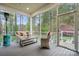 Inviting screened porch with comfortable seating and views of the serene backyard at 7268 Kiskadee Dr, Denver, NC 28037