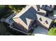 Aerial view highlighting a home with a pool, fire pit, and patio, nestled among mature trees for privacy at 7944 Park Rd, Charlotte, NC 28210