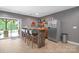 Stylish bar area with bar seating, shelving with a variety of spirits, and refrigerator at 7944 Park Rd, Charlotte, NC 28210