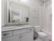 Clean bathroom with vanity, granite countertop, and a shower-tub combo at 7944 Park Rd, Charlotte, NC 28210