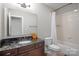Cozy bathroom with a marble countertop vanity and a tub/shower with white tiled walls at 7944 Park Rd, Charlotte, NC 28210
