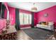 Chic bedroom with bold magenta walls, hardwood floors, and elegant décor at 7944 Park Rd, Charlotte, NC 28210