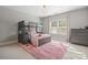 Cozy bedroom with bunk beds, soft pink rug, and dresser near a window at 7944 Park Rd, Charlotte, NC 28210
